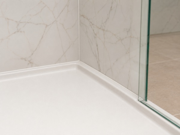 Close-up of a precisely fitted corner where two shower wall panels meet a recessed opening